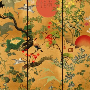 May include: A Japanese-style painting depicting a gold background with various birds, flowers, and trees. The painting features a red sun, a blue bird, and a white bird. The painting is framed in a black frame.