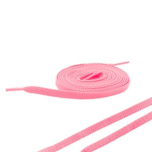 May include: Pink shoelaces, a pair of flat shoelaces in a bright pink color, are shown untied and laid out on a white background.