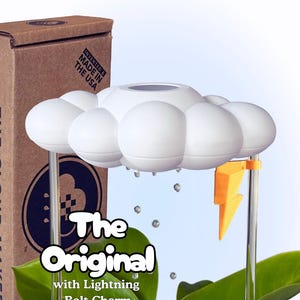 May include: A white cloud-shaped device with a yellow lightning bolt charm. The text "The Original with Lightning Bolt Charm" is displayed on the front. The product is made in the USA.