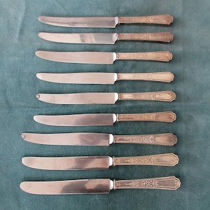 May include: A set of three ceramic mugs with a speckled, matte finish. The mugs are in shades of cream, light gray, and dark gray. Each mug has a simple, minimalist design and a rounded handle. The mugs are stacked on top of each other.