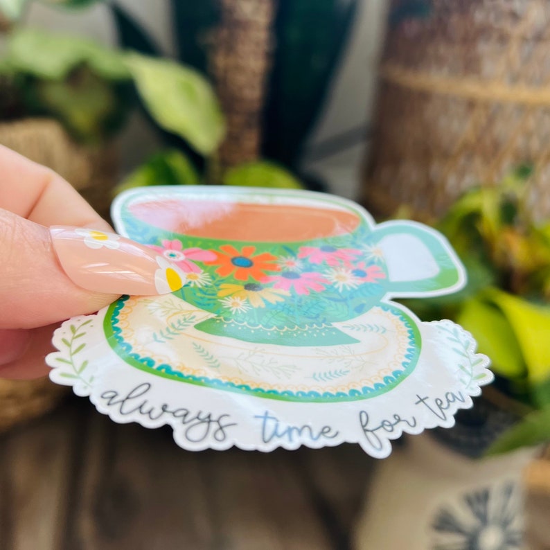 May include: A green teacup and saucer with a floral pattern and the text "always time for tea".