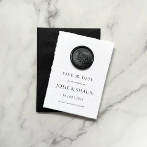May include: Save the date card with a black wax seal featuring a leaf design. The card reads "Save the Date for the wedding of Josie & Shaun 19 | 09 | 2026 Formal invitation to follow."