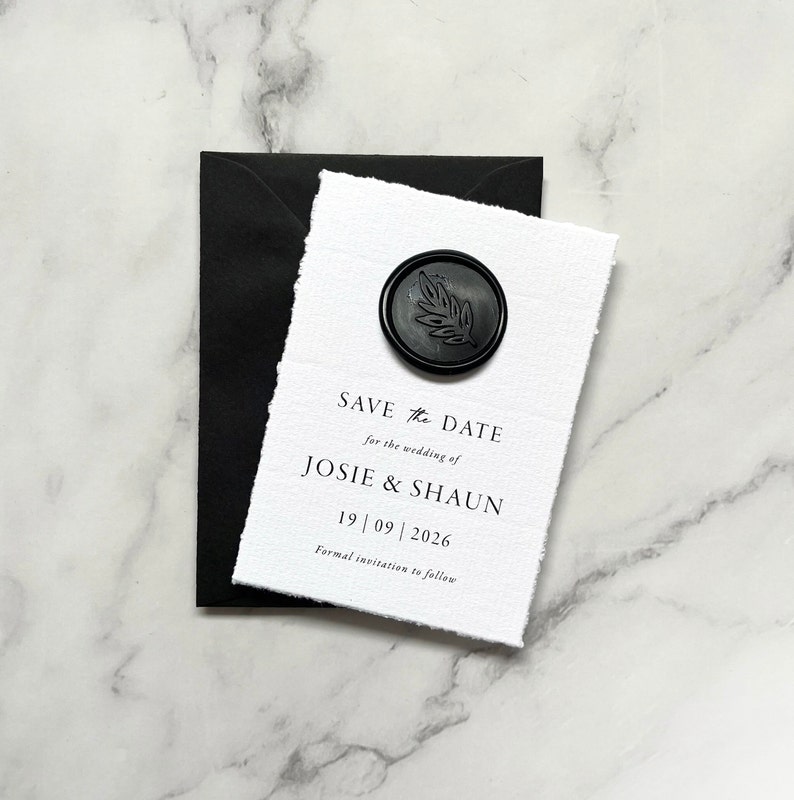 May include: Save the date card with a black wax seal featuring a leaf design. The card reads "Save the Date for the wedding of Josie & Shaun 19 | 09 | 2026 Formal invitation to follow."