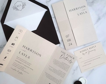 May include: A wedding invitation suite with a cream background and black text. The invitation features the names Harrison and Layla, the date Saturday 7th August 2024, and the location The Royal Building, Parr Head, Liverpool, L13 1HU. The RSVP card includes the text "Kindly Reply by 7th January".