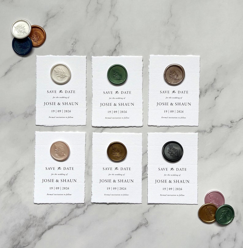 May include: Six white cards with a wax seal on each. The cards are save the date cards for a wedding. The cards say "Save the Date" for the wedding of Josie & Shaun, 19/09/2026. The wax seals are in different colors: green, brown, pink, and black.