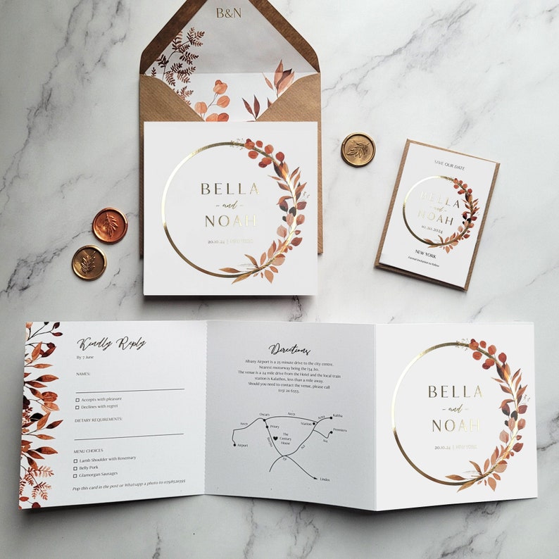 May include: A wedding invitation suite with a gold and brown floral design. The invitation features the names "Bella and Noah" in a gold circle with a watercolor floral wreath. The RSVP card includes a map with directions to the wedding venue.