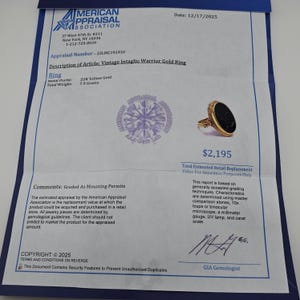 May include: A vintage gold ring with a black oval stone, presented on a blue document. The document details the ring's appraisal, metal purity, and weight of 7.9 grams. The ring's estimated retail replacement value is &pound;1,720.