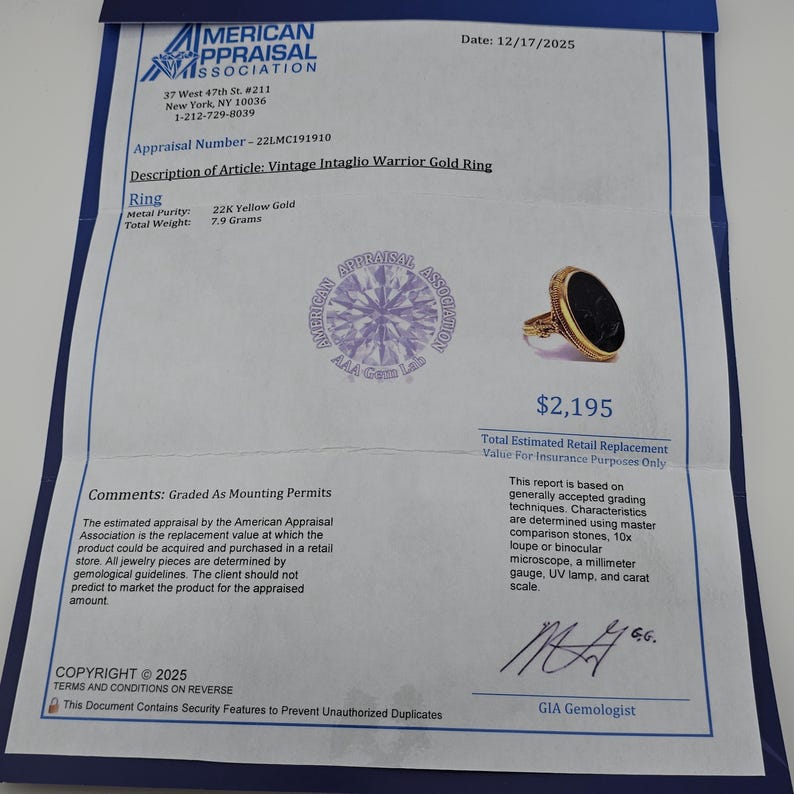 May include: A vintage gold ring with a black oval stone, presented on a blue document. The document details the ring's appraisal, metal purity, and weight of 7.9 grams. The ring's estimated retail replacement value is &pound;1,720.