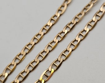 May include: A gold chain necklace with a mariner link design. The chain is made of solid gold and has a polished finish.