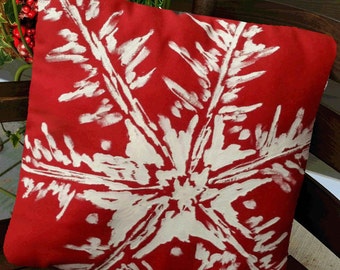 May include: Red throw pillow with a white snowflake design. The pillow is made of a soft, comfortable fabric and is perfect for adding a touch of winter cheer to your home.