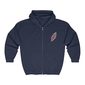 May include: A navy blue zip-up hoodie with a red and white lightning bolt graphic on the left chest. The graphic is a stylized lightning bolt with a red and white checkered pattern.