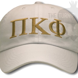 May include: White baseball cap with gold embroidered Greek letters "ΠΚΦ".