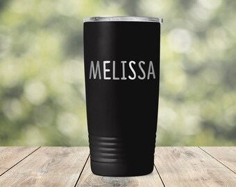 May include: A black stainless steel tumbler with a white inscription that reads "MELISSA".