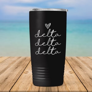 May include: Black stainless steel tumbler with a white heart and the text "delta delta delta" in a cursive font.
