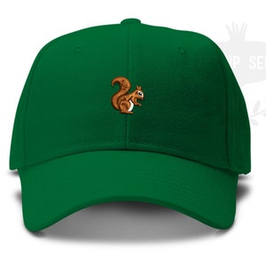 May include: A green baseball cap with a brown squirrel embroidered on the front.