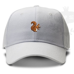 May include: A white baseball cap with an embroidered brown squirrel on the front.
