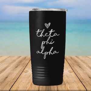 May include: Black stainless steel tumbler with a white heart and the text "theta phi alpha" in a handwritten font.
