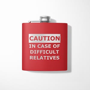 May include: Red metal flask with a silver lid and the text "CAUTION IN CASE OF DIFFICULT RELATIVES" printed on the front.