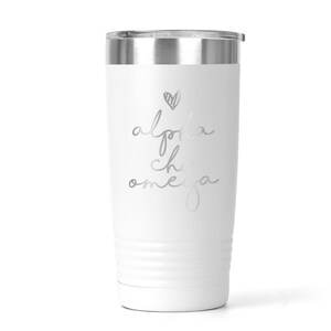 K&ouml;nnte beinhalten: Ein wei&szlig;er Edelstahlbecher mit einer silbernen Aufschrift, die "alpha chi omega" lautet, mit einem kleinen Herzen &uuml;ber dem Text.