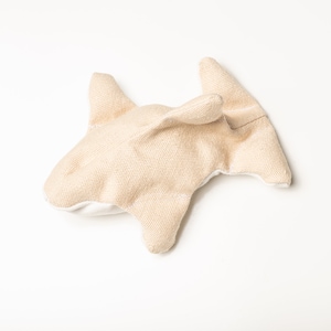 Image shows a single Organic Catnip Orca cat toy.  It is light golden brown in color.  It has 2 side fins, 1 top dorsal fin, and a wide flipper tail.  The background is light grey.  Organic Catnip Cat Toys by Purrfectplay.