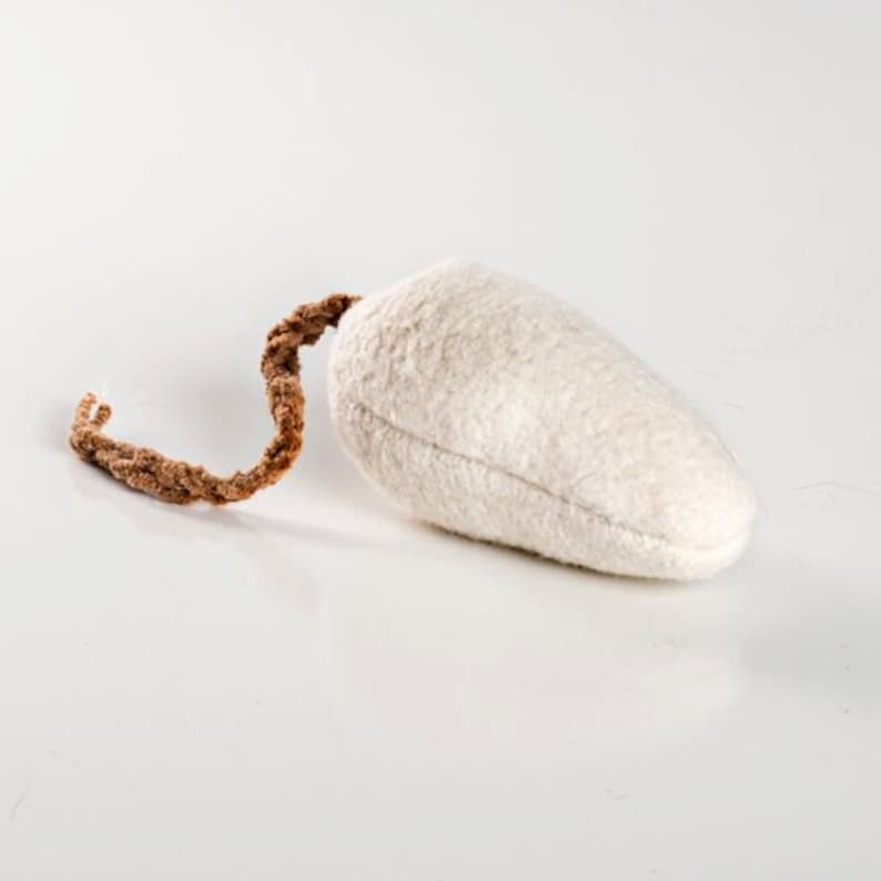 Image shows a single white fuzzy catnip mouse laying on a white surface.  Its crocheted cotton tail is naturally brown organic yarn.  Organic Catnip Cat Toys by Purrfectplay.  Natural plastic free cat toys made in the USA.