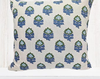 May include: Square cushion featuring a repeating floral design in blue and green hues on a cream backdrop. The fabric has a textured appearance, suitable for home decoration and adding a decorative touch.