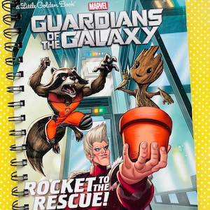 May include: A spiral-bound "Guardians of the Galaxy" children's book. The cover features Rocket Raccoon, Groot, and other characters. The title "Rocket to the Rescue!" is displayed prominently. The background is a blue and white futuristic scene.