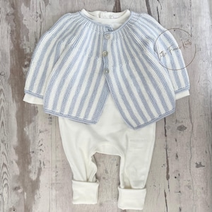 May include: A long-sleeved, light blue and white striped knit cardigan with three buttons down the front, layered over a plain white one-piece bodysuit. The cardigan features a ribbed texture and a circular logo reading Little French Knits.