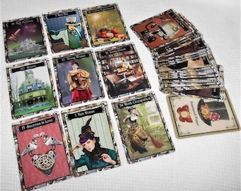 May include: A set of steampunk tarot cards with illustrations of a house, a woman, a man, a clock, and other symbols. The cards are laid out on a white surface.