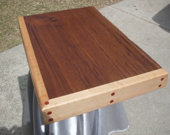 Large kitchen chopping board made out of solid Teak wood and Maple with African padauk plugs