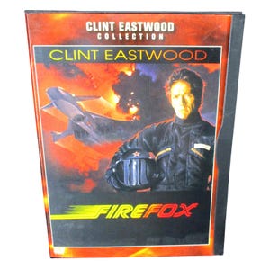 May include: A DVD case for the Clint Eastwood Collection featuring the movie Firefox. The cover art displays a person in a black flight suit holding a helmet, with a fighter jet flying against a fiery orange and black background. The text reads Clint Eastwood Collection, Clint Eastwood, and Firefox.