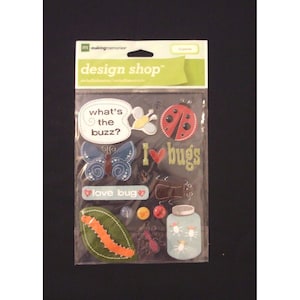 May include: A package of scrapbook stickers with a bug theme. The stickers include a ladybug, butterfly, and the phrase "I love bugs." Other stickers include a leaf with a caterpillar and a jar with fireflies.