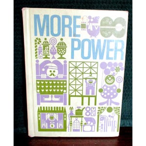 May include: A vintage book cover with the words "MORE POWER" in blue and white. The cover features various green and purple illustrations, including a clown, a guitar, and geometric shapes. The book has a white spine.