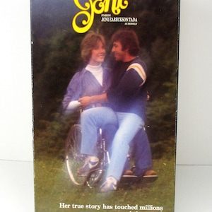 May include: A VHS tape cover featuring a photo of Joni Eareckson Tada, a woman in a wheelchair, with a man sitting beside her. The cover is titled "Joni" and reads "You've never met anyone quite like Joni" and "Her true story has touched millions around the world."