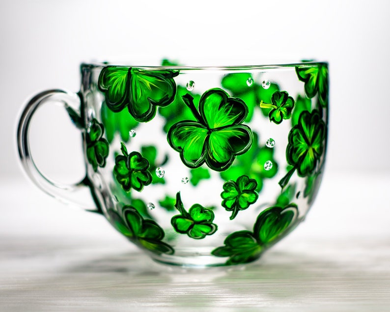 St Patricks Day glass cup with green shamrock and clover design.