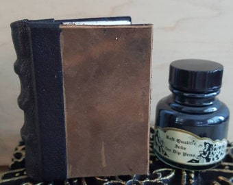 Small medieval hand bound leather book with illuminated Renaissance endpages