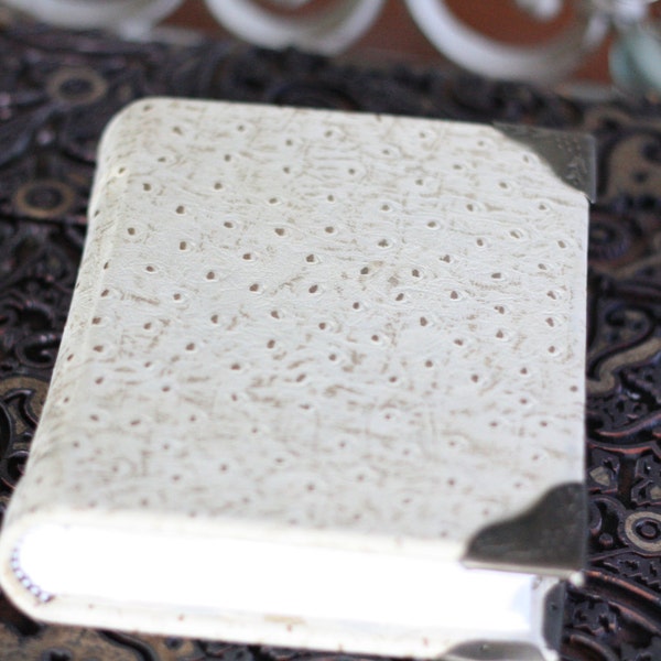 Hand bound cream colored soft blank leather journal with antique style brass corners, and gingko end paper.