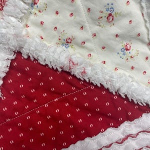 May include: A white ceramic mug with a black handle and the text "But First, Coffee" in a bold, black font. The mug is set against a neutral background, highlighting its simple design.