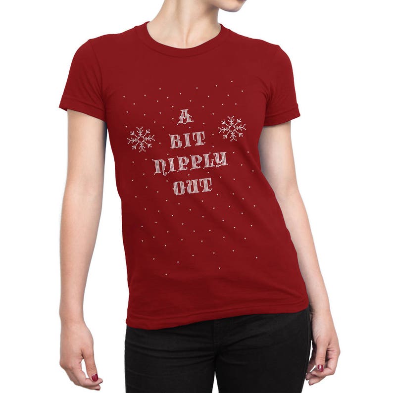 May include: Red t-shirt with a white snowflake design and the text "A Bit Dippy Out" in a pixelated font.
