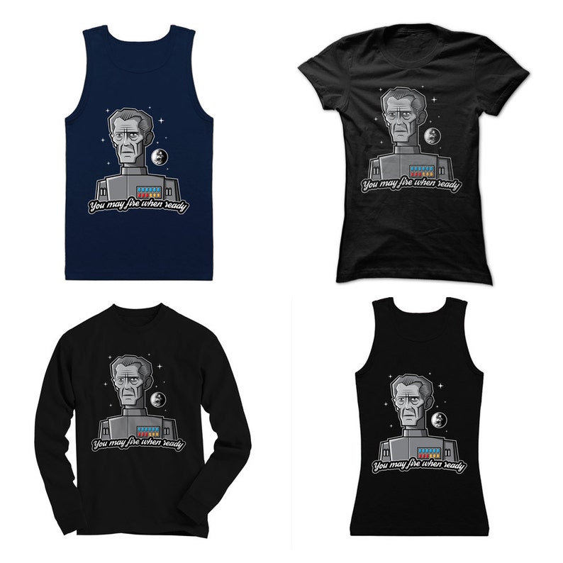 May include: Four different t-shirts featuring a cartoon image of a man with the text "You may fire when ready". The shirts are available in black, navy blue, and white.