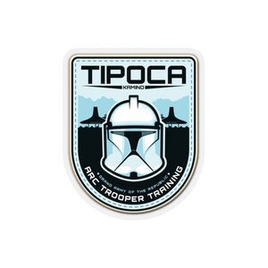 May include: A blue and white sticker with a white helmet and the text "TIPOCA KAMINO GRAND ARMY OF THE REPUBLIC ARC TROOPER TRAINING".