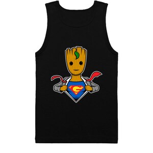 May include: A black tank top with a cartoon image of a tree-like character wearing a suit and revealing a Superman logo underneath. The character has a green leaf on its head.