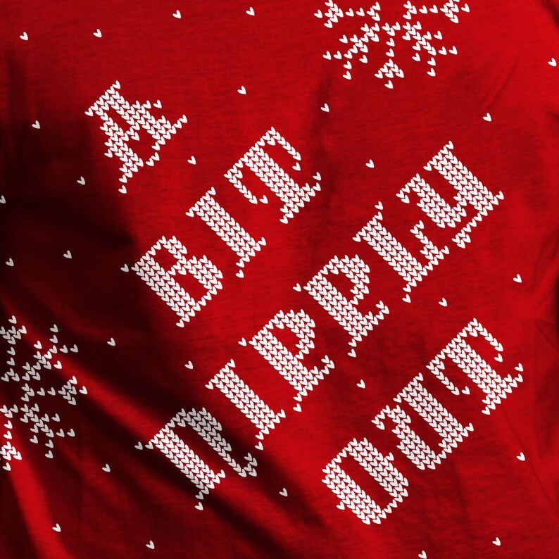 May include: Red knitted sweater with a white knitted design that says "A Big Ol' Cup Of" in a festive holiday style.