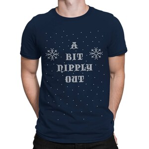May include: A navy blue t-shirt with a white snowflake design and the text "A Bit Dippy Out" in a white, pixelated font.