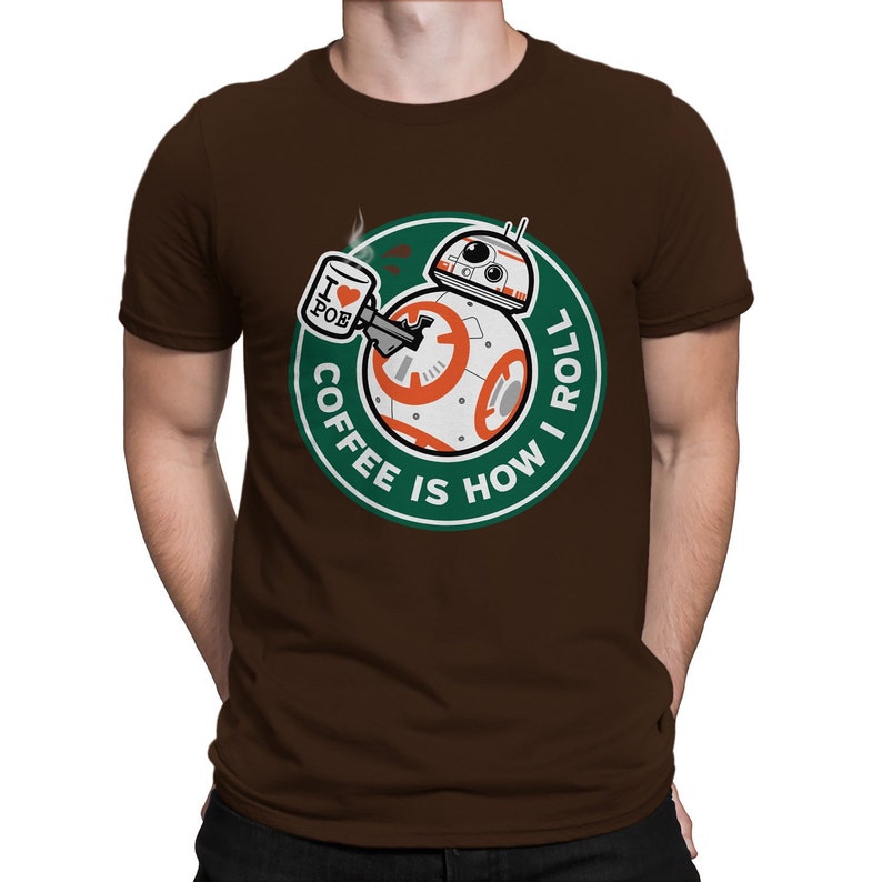 May include: Brown t-shirt with a green circle graphic featuring a Star Wars BB-8 droid holding a coffee cup with the text "I love Poe" on it. The text around the droid reads "Coffee is how I roll."