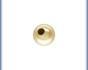May include: A single, round, gold-colored bead with a hole in the center.