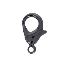 May include: Black metal lobster clasp with a spring-loaded gate. This clasp is commonly used for jewelry making and crafting.