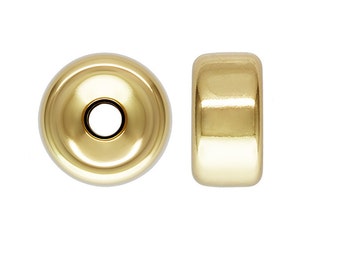 May include: Gold-toned metal bead with a smooth, rounded surface. The bead has a hole in the center for stringing.
