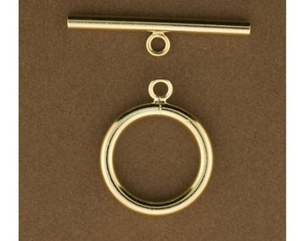 May include: Gold-toned metal toggle clasp with a round ring and a straight bar. The clasp is a jewelry finding for necklaces, bracelets, and other jewelry projects.