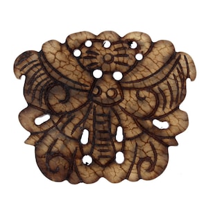 May include: A brown carved wooden pendant in the shape of a butterfly with intricate details. The pendant has a distressed look and is made of natural wood.